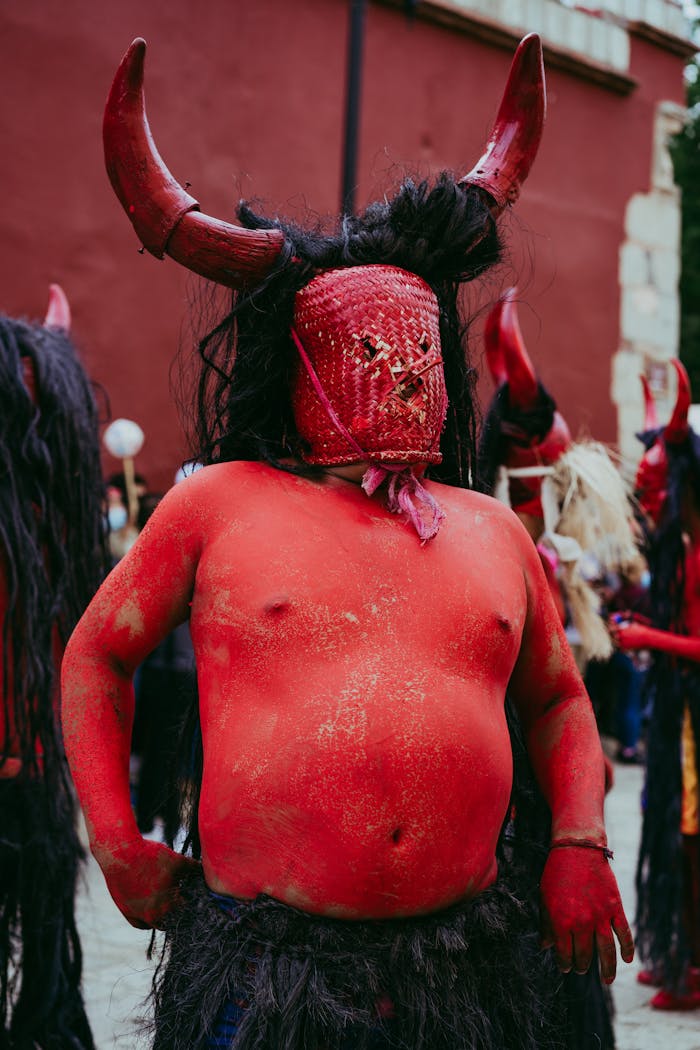 A vibrant display of Mexican culture with a devil mask at a festival in Oaxaca, Mexico.