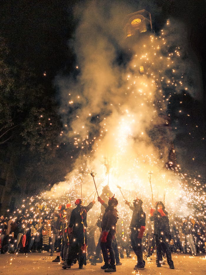 Captivating scene of a night festival with fireworks and vibrant cultural rituals in Barcelona, Spain.