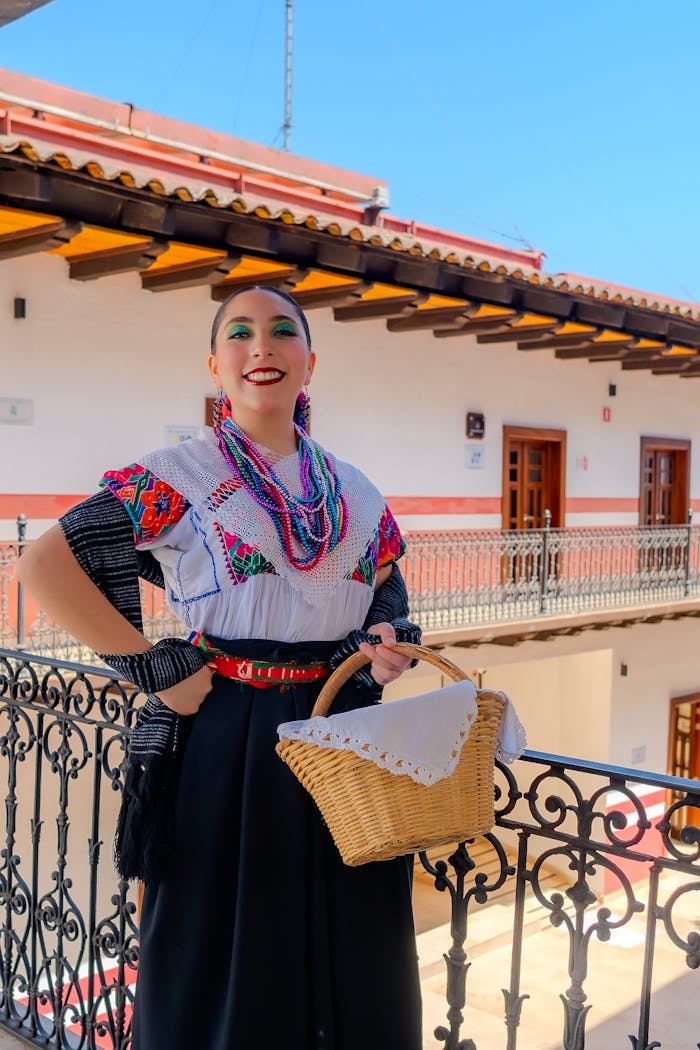 Woman in traditional Mexican attire posing with a basket in Huauchinango, Mexico.
